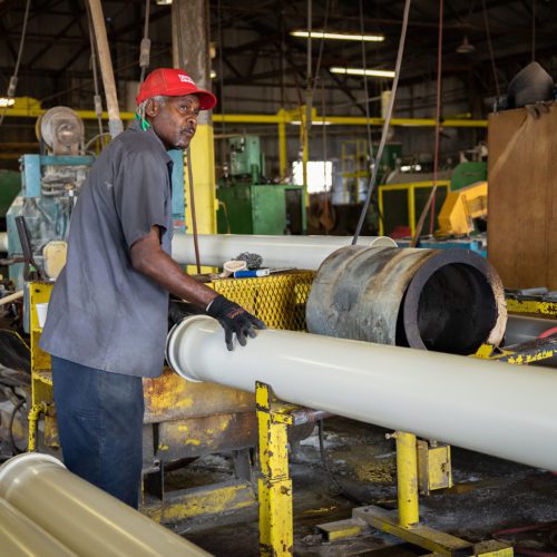Worker cutting large pipe
